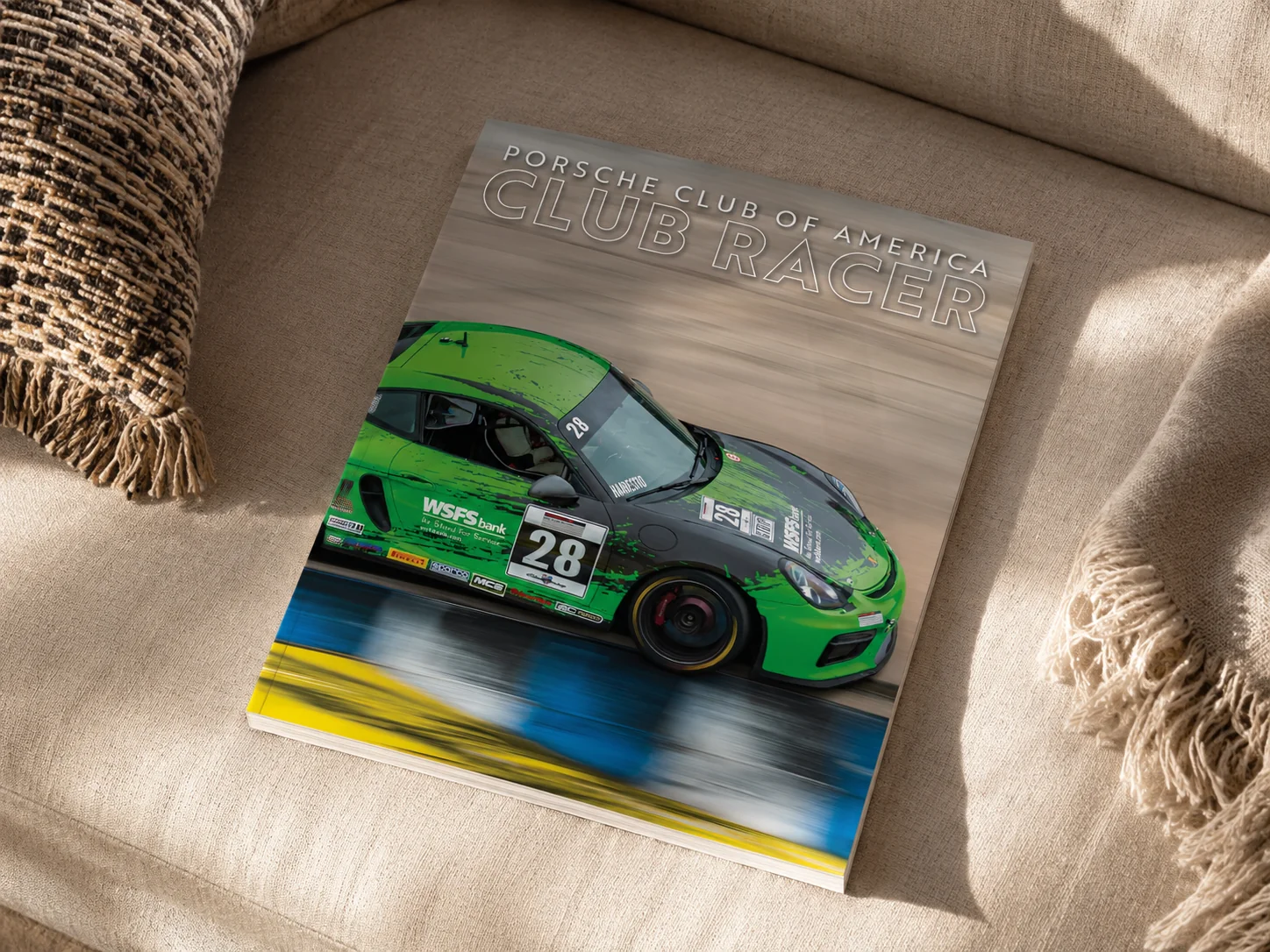 Porsche Club of America Club Racer December 2025 cover featuring a green and black Cayman GT4 race car at speed.