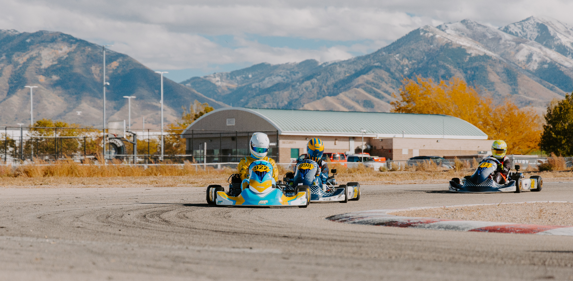 Tight pack of karts battling through a corner during round ten of a karting championship.
